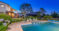 Two storey house and pool at dusk with golden lighting