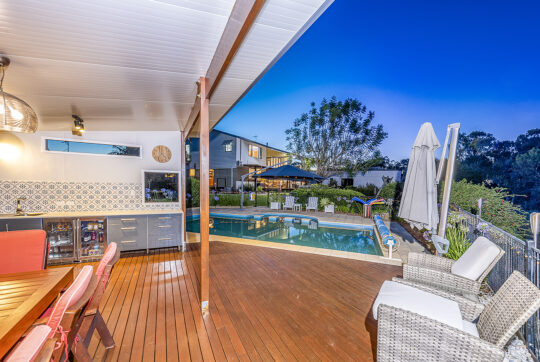 View to house from outdoor entertaining area in pool yard