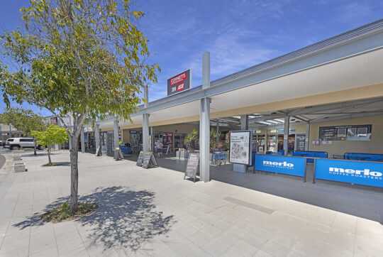 Looking at main entry into Northway Plaza Shopping Centre from the footpath