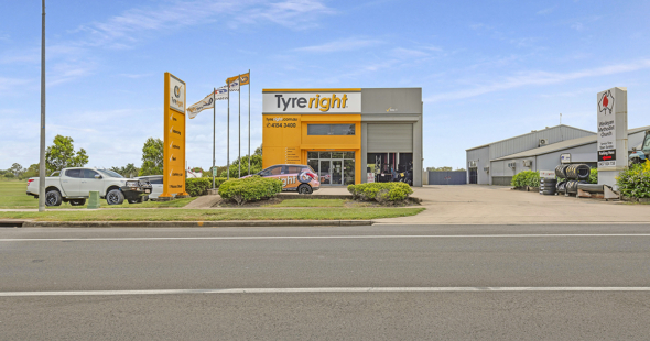 Large yellow and grey concrete building by WK Projects