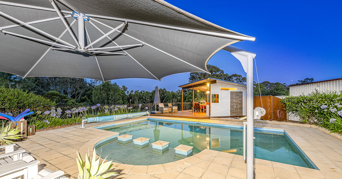 Overlooking the pool area of 4 Melcer Ct to the outdoor entertaining area