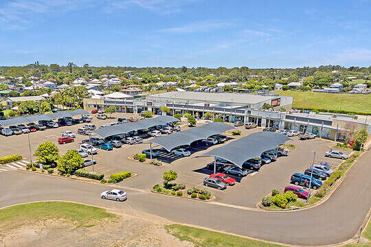 Aerial view of shopping complex with undercover parking